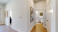 Located in Queen Creek, AZ, this single-story, one-bedroom, one-bathroom residence offers a well-designed layout that maximizes every square foot of its compact footprint. The open-concept living, dining, and kitchen area forms the heart of the home, bathed in natural light from large windows and a sliding glass door that opens directly onto a private patio. The kitchen is outfitted with white shaker cabinetry, granite countertops, a subway tile backsplash, stainless steel appliances including a refrigerator, electric range, and microwave, and a peninsula with bar seating that seamlessly connects to the dining area. Light-toned wood-style flooring runs throughout the main living spaces, adding warmth and continuity. The living room offers a comfortable, airy atmosphere with a window view to the outdoors. A dedicated hallway leads to the bedroom, which features soft carpet flooring, multiple windows that invite natural light, and a spacious closet. The full bathroom is appointed with a granite-topped vanity, white cabinetry, and a tiled tub-shower combination. Additional conveniences include a pantry, in-unit laundry, and a dedicated hallway with smart thermostat access, rounding out this efficiently planned and contemporary residence.