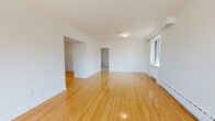 Located at 1641 Bathurst Street in Toronto's vibrant Midtown neighbourhood, this generously sized 4-bedroom, 2-bathroom unit offers a bright and functional single-floor layout. Warm-toned hardwood flooring flows throughout the living areas and bedrooms, lending a clean, cohesive feel to the space. The open living room is bathed in natural light from large windows that frame views of mature trees, with baseboard heating running along the walls for year-round comfort. The modern kitchen is well-appointed with white shaker-style cabinetry, dark countertops, white subway tile backsplash, stainless steel appliances including a refrigerator and dishwasher, and a window overlooking the outdoors. The four bedrooms are generously proportioned, each with hardwood floors and natural light; the primary bedroom is notably spacious and includes a closet. The two bathrooms are tastefully finished — one features a white vanity with a mirror and tile flooring, while the other includes a soaking tub with a full subway-tiled surround and shower. Two hallways connect the rooms efficiently, and a dedicated closet provides additional storage. The overall ambiance is clean, bright, and move-in ready.