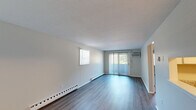Located at 83 Mansfield Rd in New London, CT, this one-bedroom, one-bathroom unit offers a well-organized single-floor layout designed for efficient, comfortable living. The living room is bright and open, featuring durable hardwood-style flooring, a sliding glass door with vertical blinds that invites natural light and outdoor views, an additional side window, and a baseboard heating system. A wall-mounted AC unit provides climate control convenience.

The kitchen has been thoughtfully updated with white shaker-style cabinetry, granite-style countertops, stainless steel appliances including a range, microwave, and dishwasher, and a stainless steel sink — all finished with light hardwood-style flooring.

The bedroom is carpeted for comfort, features a natural light-filled window with blinds, a textured ceiling, baseboard heating, and a full-width double-door closet for ample storage. Notably, the unit includes four total closets, providing exceptional storage throughout.

The bathroom is clean and functional, outfitted with a full tub-shower combo, toilet, and light hardwood-style flooring. A hallway connects the main rooms, contributing to a logical and accessible flow throughout the unit.
