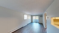 Located at 83 Mansfield Rd in New London, CT, this one-bedroom, one-bathroom unit offers a well-organized single-floor layout designed for efficient, comfortable living. The living room is bright and open, featuring durable hardwood-style flooring, a sliding glass door with vertical blinds that invites natural light and outdoor views, an additional side window, and a baseboard heating system. A wall-mounted AC unit provides climate control convenience.

The kitchen has been thoughtfully updated with white shaker-style cabinetry, granite-style countertops, stainless steel appliances including a range, microwave, and dishwasher, and a stainless steel sink — all finished with light hardwood-style flooring.

The bedroom is carpeted for comfort, features a natural light-filled window with blinds, a textured ceiling, baseboard heating, and a full-width double-door closet for ample storage. Notably, the unit includes four total closets, providing exceptional storage throughout.

The bathroom is clean and functional, outfitted with a full tub-shower combo, toilet, and light hardwood-style flooring. A hallway connects the main rooms, contributing to a logical and accessible flow throughout the unit.