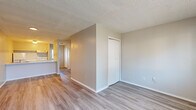 Located in Sherwood, AR, this single-floor unit offers a straightforward, efficient layout designed for comfortable everyday living. The open-concept kitchen and living area serves as the heart of the space, where light wood-style vinyl flooring runs continuously throughout, creating a cohesive and clean aesthetic. Neutral-toned walls and textured ceilings provide a simple backdrop that maximizes the sense of openness.

The kitchen is equipped with a white electric range, refrigerator, and an overhead ventilation hood. A peninsula counter with a light-toned surface and an integrated double sink separates the kitchen from the living area, offering both workspace and a casual dining option. Natural light filters in through a window near the entry.

The living area is open and unobstructed, with a front-facing window fitted with blinds and a wall-mounted HVAC unit for climate control. A closet with bi-fold doors provides convenient in-unit storage.

The bathroom features a vanity with a single sink, a mirrored medicine cabinet, and overhead lighting, maintaining the same clean, light flooring found throughout the unit. The layout is compact yet functional, making efficient use of every square foot this Sherwood residence has to offer.