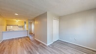 Located in Sherwood, AR, this single-floor unit offers a straightforward, efficient layout designed for comfortable everyday living. The open-concept kitchen and living area serves as the heart of the space, where light wood-style vinyl flooring runs continuously throughout, creating a cohesive and clean aesthetic. Neutral-toned walls and textured ceilings provide a simple backdrop that maximizes the sense of openness.

The kitchen is equipped with a white electric range, refrigerator, and an overhead ventilation hood. A peninsula counter with a light-toned surface and an integrated double sink separates the kitchen from the living area, offering both workspace and a casual dining option. Natural light filters in through a window near the entry.

The living area is open and unobstructed, with a front-facing window fitted with blinds and a wall-mounted HVAC unit for climate control. A closet with bi-fold doors provides convenient in-unit storage.

The bathroom features a vanity with a single sink, a mirrored medicine cabinet, and overhead lighting, maintaining the same clean, light flooring found throughout the unit. The layout is compact yet functional, making efficient use of every square foot this Sherwood residence has to offer.
