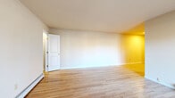 Located at 47 Madison Gardens in Old Bridge, NJ, this well-appointed one-bedroom, one-bathroom residence offers a practical and comfortable single-floor layout. Gleaming hardwood floors run throughout the main living areas, lending warmth and continuity to the space. The living room is generously proportioned, filled with natural light from a large sliding glass door that opens onto a private balcony with outdoor views — an inviting feature that enhances the sense of openness. The kitchen is thoughtfully designed in a galley configuration, featuring dark cabinetry with modern hardware, white quartz countertops, a subway tile backsplash, and a full suite of appliances including a gas range, dishwasher, and refrigerator. Light wood-toned flooring in the kitchen complements the overall aesthetic. The spacious bedroom offers hardwood floors, a window with natural light, and two closets providing ample storage. The full bathroom is clean and bright, with white subway tile surround, a tub-shower combo, a window for natural ventilation, and a dark-toned vanity with a white countertop. Baseboard heating is present throughout, and the layout flows efficiently from room to room, making this a practical and inviting residence.