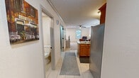 Located in Boones Creek Village in Jonesborough, Tennessee, this two-bedroom, two-bathroom home is thoughtfully laid out across two floors of comfortable living space. The main level features a combined kitchen and living area, where light tile flooring flows throughout. The kitchen is equipped with warm wood cabinetry, stainless steel appliances including a refrigerator, microwave, and range, along with a double-basin sink and a peninsula that opens to the living area. The living room is bright and welcoming, with a ceiling fan, recessed lighting, natural light from a window with outdoor views, and a front entry door with glass paneling. A full bathroom with a vanity and wood cabinetry is also conveniently located on the main floor. A dedicated laundry room houses a full-size washer and dryer with overhead shelving. Upstairs, two carpeted bedrooms each feature ceiling fans and ample natural light. The primary bedroom offers generous proportions, while the second bedroom is cozy and well-appointed. A second full bathroom with a wood vanity and large mirror serves the upper level. Two closets provide additional storage throughout the home. The textured ceilings and neutral palette create a clean, practical living environment throughout.
