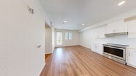 This contemporary 2-bedroom apartment in San Diego offers 640 square feet of efficiently designed living space. The open-concept layout combines the kitchen and living area, creating a spacious feel. The kitchen boasts sleek white cabinetry, stainless steel appliances, and a subway tile backsplash, perfect for culinary enthusiasts.

Both bedrooms feature wood flooring and large windows that flood the spaces with natural light. The primary bedroom, measuring 110 square feet, provides ample space for a comfortable retreat. The bathroom is modern and functional, with a white vanity, large mirror, and a shower/tub combination.

Throughout the apartment, recessed lighting and white walls contribute to the bright, airy ambiance. The property includes two hallways for easy navigation between rooms. Large windows with blinds offer views of the surrounding area and allow for privacy control.

The exterior of the building showcases a modern architectural design with clean lines and a mix of white and yellow accents. A balcony with metal railings provides outdoor space and city views.

Located in the 92117 zip code of San Diego, this apartment combines style and functionality in a desirable urban setting. Its contemporary design and efficient use of space make it an attractive option for those seeking a modern living experience in Southern California.