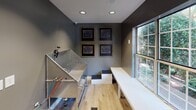 Located at 6312 Reafield Dr in Charlotte, NC, this single-floor space is purpose-built for pet grooming services. The interior is finished with dark gray walls and light wood-tone flooring, creating a clean, modern aesthetic throughout.

The main grooming area centers around a stainless steel bathing station equipped with a handheld sprayer, non-slip grating, and clear acrylic splash guards, designed for efficient and safe pet washing. Adjacent to the tub, a set of low steps provides easy pet access. A white grooming table positioned near the large windows offers ample workspace, with recessed lighting overhead ensuring consistent illumination across the room.

Large windows along one wall allow natural light to fill the space and provide views of the surrounding greenery. A glass-paned exit door, fitted with a keypad entry system and illuminated exit signage, connects the space to an outdoor area. Four framed animal anatomy prints are displayed on the wall, adding a professional, veterinary-inspired decorative touch. The overall layout is functional and well-organized, catering specifically to professional pet care operations.