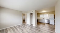 Located at 2330 Hampstead Avenue in Richmond, Virginia, this 2-bedroom, 1-bathroom residence offers a clean, modern interior across a single, efficiently arranged floor. Light-toned luxury vinyl plank flooring runs throughout the entire space, creating a cohesive and easy-to-maintain aesthetic. Neutral warm-gray walls complement the bright trim and white doors found in every room.

The open living area connects directly to the kitchen, which features gray shaker-style cabinetry, classic white subway tile backsplash, stainless steel appliances including a dishwasher and gas range, a single-basin sink beneath a natural light-admitting window, and a convenient in-unit stacked washer and dryer. Built-in open shelving provides additional storage in the kitchen area.

Both bedrooms are finished with the same LVP flooring and neutral wall tones. The primary bedroom includes a dedicated closet with a hanging rod, while the second bedroom benefits from a large window that fills the room with natural light and outdoor views. A centrally located hallway closet adds further storage.

The bathroom is bright and clean, featuring textured wave-tile wall surrounds in the tub/shower combination, chrome fixtures, and a window that introduces natural light. The overall layout is practical and well-organized, making efficient use of the available space throughout.