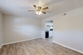 Located at 5100 Highpoint Rd in Union City, GA, this one-bedroom, one-bathroom unit offers a well-organized, single-floor layout designed to maximize every inch of available space. Throughout the unit, wood-look plank flooring provides a clean, cohesive look, while neutral gray-toned walls create a bright and airy atmosphere.

The combined living and dining area serves as the heart of the home, featuring a ceiling fan with integrated lighting and a textured ceiling. A window allows natural light to filter in, and an open pass-through connects directly to the kitchen, enhancing the sense of openness.

The galley-style kitchen is efficiently designed with white cabinetry, light countertops, a single-basin sink, and a full suite of black appliances including an electric range, dishwasher, and refrigerator. An under-cabinet range hood and ample upper and lower cabinet storage round out the functional space.

The bedroom is a comfortable, well-proportioned retreat featuring a ceiling fan, a window with blinds offering natural light and outdoor views, and two closets providing generous storage. The full bathroom includes a tiled shower-tub combination with chrome fixtures and a clean white vanity.