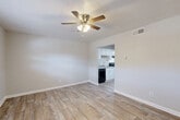 Located at 5100 Highpoint Rd in Union City, GA, this one-bedroom, one-bathroom unit offers a well-organized, single-floor layout designed to maximize every inch of available space. Throughout the unit, wood-look plank flooring provides a clean, cohesive look, while neutral gray-toned walls create a bright and airy atmosphere.

The combined living and dining area serves as the heart of the home, featuring a ceiling fan with integrated lighting and a textured ceiling. A window allows natural light to filter in, and an open pass-through connects directly to the kitchen, enhancing the sense of openness.

The galley-style kitchen is efficiently designed with white cabinetry, light countertops, a single-basin sink, and a full suite of black appliances including an electric range, dishwasher, and refrigerator. An under-cabinet range hood and ample upper and lower cabinet storage round out the functional space.

The bedroom is a comfortable, well-proportioned retreat featuring a ceiling fan, a window with blinds offering natural light and outdoor views, and two closets providing generous storage. The full bathroom includes a tiled shower-tub combination with chrome fixtures and a clean white vanity.