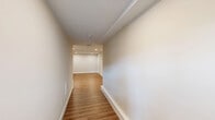 Located at 5 Eagle Brook Blvd in Wrentham, MA, this three-floor townhouse offers 2 bedrooms and 3 bathrooms thoughtfully distributed across well-proportioned living spaces. The entry-level garage and finished lower level — featuring recessed lighting and warm wood-look luxury vinyl plank flooring — provide flexible space ideal for a recreation room, home office, or additional living area. The main floor serves as the heart of the home, where an open-concept layout connects the kitchen, dining room, and living room. The kitchen is outfitted with white shaker cabinetry, stainless steel appliances including a refrigerator, range, and over-the-range microwave, all set atop the same light hardwood-style flooring that flows throughout. A deck off the main level extends the living space outdoors, offering views of the surrounding treeline and open sky. The upper floor hosts both bedrooms, including a generously sized primary bedroom, each carpeted for comfort and featuring windows that bring in natural light. The bedrooms are complemented by closet space and well-appointed bathrooms with clean, neutral finishes. The home's consistent palette of warm neutrals and crisp white trim creates a cohesive, move-in-ready aesthetic throughout.