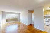 Located at 3839 64th Ave in Hyattsville, MD, this one-bedroom, one-bathroom unit offers a well-organized single-floor layout with a clean, functional design. Distinctive parquet wood flooring flows consistently throughout the entire space, adding warmth and classic character to every room.

The combined living and dining area forms the heart of the unit, offering an open, versatile space bathed in natural light from a wide picture window overlooking surrounding trees. The layout flows naturally from the entry hallway into this central living zone, creating an easy sense of connectivity throughout.

The kitchen is efficiently designed, featuring light wood cabinetry, a laminate countertop with an integrated sink, a full-size refrigerator, and a dishwasher — providing all the essentials in a compact footprint with tile flooring.

The bedroom is a comfortable, quiet retreat with its own large window framing outdoor greenery, and is served by a generous double-door closet. Additional closets are distributed throughout the unit — four in total — offering exceptional storage capacity relative to the size of the space.

The bathroom includes a full tub-and-shower combination with white tile surround, maintaining a simple and clean aesthetic. Neutral gray walls and white trim are consistent throughout, lending the unit a bright, cohesive appearance.