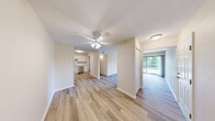 Located at 80 Rossway Ave in Rossford, Ohio, this 2-bedroom, 1-bathroom residence offers a practical and comfortable single-floor layout. The open-concept living and kitchen area serves as the heart of the home, where light wood-style laminate flooring extends throughout. The kitchen is outfitted with crisp white shaker cabinetry, marble-look countertops, a subway tile backsplash, and a full suite of stainless steel appliances including a gas range, dishwasher, microwave, and refrigerator. The living area is bright and airy, with a ceiling fan overhead and sliding glass doors that open directly onto a private balcony, offering pleasant outdoor views and natural light. Both bedrooms feature soft wall-to-wall carpeting and ample natural light from windows. The primary bedroom includes a sliding double-door closet, providing generous storage. The full bathroom is clean and modern, featuring a white vanity with under-cabinet storage, a framed mirror, and brushed nickel fixtures with stylish lighting. A dedicated hallway connects the rooms efficiently, and an additional closet adds to the overall storage capacity of the unit. The neutral warm-toned walls throughout create a cohesive and inviting ambiance.