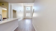 This contemporary townhouse in Marina Del Rey offers 1500 square feet of living space spread across two floors. The lower level spans 1060 square feet, while the upper floor covers 440 square feet. The property features two bedrooms, including a spacious primary bedroom of 190 square feet, and two full bathrooms.

The interior showcases modern design elements throughout. The kitchen boasts sleek, dark wood cabinetry, stainless steel appliances, and a subway tile backsplash. The open-concept layout seamlessly connects the kitchen to the living area, which is adorned with light wood flooring, creating a warm and inviting atmosphere.

Both bathrooms feature modern fixtures, including floating vanities with ample storage space. The larger bathroom includes a combination bathtub and shower, while the other offers a stand-alone shower. The dedicated laundry room comes equipped with full-sized washer and dryer units.

The bedrooms are carpeted for comfort and include built-in closets with wire shelving systems. Large windows in the bedrooms allow for natural light and offer views of the surrounding area.

This townhouse unit, located at 3221 Carter Ave, Unit 408, provides a blend of style and functionality in the desirable Marina Del Rey neighborhood.