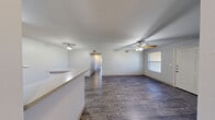 This single-story, 3-bedroom, 2-bathroom home offers a practical and well-organized layout designed to maximize every square foot. Wood-look plank flooring runs throughout the entire residence, lending a cohesive and low-maintenance aesthetic from room to room.

The open living and dining area is anchored by a ceiling fan and flows naturally into the kitchen, which features warm honey-toned wood cabinetry, a gas range, a refrigerator, and a peninsula counter that provides additional prep space and separates the kitchen from the main living area. A pantry adds further storage convenience adjacent to the kitchen.

The primary bedroom is a comfortable, well-proportioned retreat. All three bedrooms are fitted with ceiling fans and benefit from the consistent wood-look flooring. The home includes an impressive five closets in total, ensuring plentiful storage throughout.

Both bathrooms are functional and clean in design, with one featuring a tub/shower combination, a vanity with under-sink cabinetry, and a large mirror with overhead lighting. A hallway connects the bedrooms to the main living spaces, keeping the floor plan efficient and easy to navigate.

An outdoor patio extends the living space and provides a dedicated area for relaxation. The home's straightforward, single-floor design makes it accessible and easy to maintain.