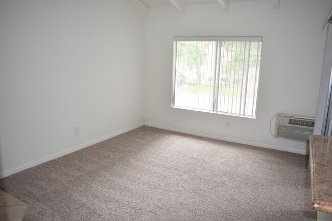 Building Photo - Upper-Level Condo with Vaulted Ceilings & Granite Finishes