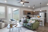 Located at 116 S Kcid Rd in Caldwell, Idaho, this two-story home offers a well-organized layout across two floors with a clean, contemporary aesthetic. The exterior presents a striking board-and-batten façade with warm wood accents, a attached garage with a modern paneled door, and a privacy-fenced backyard.

The main level houses an open-concept kitchen and living room, where warm wood-toned cabinetry, white countertops, and stainless steel appliances create a functional and inviting space. Wood-look flooring flows through the main areas, while a hallway leads efficiently to other parts of the home. A pantry, laundry room, and garage access add practical convenience on this floor.

Upstairs, three carpeted bedrooms provide comfortable retreats. The primary bedroom features a window for natural light and a direct connection to its own en-suite bathroom with a vanity and tub/shower combination. Additional bedrooms are well-proportioned, each with closet storage. The home includes five bathrooms in total, ensuring ample accommodation for residents and guests alike.

With four closets spread throughout, a dedicated staircase connecting the floors, and a spacious garage that houses utilities including the electrical panel and water heater, this home is designed for both comfort and practicality in a growing Caldwell neighborhood.