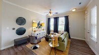 Located at 1421 Baseline Rd in Charlotte, NC, this single-floor residence offers a thoughtfully designed layout with a cohesive blend of modern finishes and warm, neutral tones throughout. The living room serves as a welcoming centerpiece, featuring wood-look flooring, crown molding, a ceiling fan, and multiple windows that invite natural light and outdoor views. Adjacent to the living area, the dining space is defined by a bay window arrangement with full-length drapes, creating an elegant setting for entertaining.

The kitchen is well-equipped with rich dark cabinetry, granite-style countertops, a green glass tile backsplash, and stainless steel appliances including a range and over-the-range microwave. A private entry door with a sidelight window adds convenient access.

The bedrooms offer plush carpeting, ceiling fans, and generous natural light from multiple windows, including bay-style configurations. Each bedroom provides a comfortable and private retreat with ample space.

The bathrooms are finished consistently with dark vanity cabinetry, granite-style countertops, and tiled tub-shower combinations with wood-look flooring, maintaining a cohesive aesthetic across the residence. The overall design balances practicality with an elevated, modern sensibility.