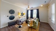 Located at 1421 Baseline Rd in Charlotte, NC, this single-floor residence offers a thoughtfully designed layout with a cohesive blend of modern finishes and warm, neutral tones throughout. The living room serves as a welcoming centerpiece, featuring wood-look flooring, crown molding, a ceiling fan, and multiple windows that invite natural light and outdoor views. Adjacent to the living area, the dining space is defined by a bay window arrangement with full-length drapes, creating an elegant setting for entertaining.

The kitchen is well-equipped with rich dark cabinetry, granite-style countertops, a green glass tile backsplash, and stainless steel appliances including a range and over-the-range microwave. A private entry door with a sidelight window adds convenient access.

The bedrooms offer plush carpeting, ceiling fans, and generous natural light from multiple windows, including bay-style configurations. Each bedroom provides a comfortable and private retreat with ample space.

The bathrooms are finished consistently with dark vanity cabinetry, granite-style countertops, and tiled tub-shower combinations with wood-look flooring, maintaining a cohesive aesthetic across the residence. The overall design balances practicality with an elevated, modern sensibility.