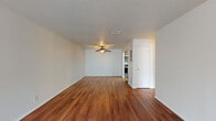 This 710 square foot apartment, located in Summit West - 32E - A1, offers a thoughtfully designed one-bedroom, one-bathroom layout. The space maximizes functionality while maintaining an open, airy feel. Upon entry, you're greeted by stunning hardwood floors that flow throughout the entire apartment, adding warmth and elegance.

The living area is spacious and bright, featuring a large window that floods the room with natural light. A stylish ceiling fan provides both illumination and air circulation. The bedroom, measuring 170 square feet, offers ample space for a comfortable retreat.

The kitchen is a highlight, boasting modern stainless steel appliances, rich wooden cabinetry, and sleek granite countertops. White subway tile backsplash adds a contemporary touch. The galley-style layout ensures efficiency without sacrificing style.

Additional features include a closet for storage, and a well-appointed bathroom. The apartment's neutral color palette provides a blank canvas for personal decoration. With its blend of modern amenities and thoughtful design, this apartment offers a perfect balance of comfort and style for urban living.