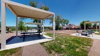Located at 834 Chapman Dr in Colorado Springs, CO, this two-floor residential community offers a compelling blend of comfortable living and thoughtfully designed outdoor spaces. The property is framed by breathtaking views of the Rocky Mountains, visible from multiple points across the grounds, providing a dramatic natural backdrop to everyday life.

The outdoor amenities are a standout feature of this community. A covered pergola-style pavilion serves as a central gathering space, equipped with a built-in BBQ grill station and picnic table seating — ideal for outdoor dining and social gatherings. Adjacent to the pavilion, a dedicated seating area with chairs beneath a secondary pergola structure provides a relaxed spot to unwind.

A well-maintained playground with colorful equipment is situated within the grounds, offering recreational space for younger residents. Mature shade trees are distributed throughout the property, lending a sense of established greenery and natural comfort to the outdoor environment.

The community also features a generously sized open lawn area enclosed by wrought iron fencing, which appears to function as a dog park or open recreation space. Concrete walkways wind throughout the grounds, connecting the various amenity areas in a clean and accessible layout. The exterior building design incorporates stucco finishes with a welcoming, neighborhood-oriented aesthetic that complements the surrounding Colorado Springs community.