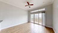 This oceanfront unit offers a well-appointed single-floor layout with two bedrooms and one and a half bathrooms, combining coastal practicality with clean, updated finishes throughout. Wood-look tile flooring runs consistently across the living spaces, providing a warm yet low-maintenance foundation that complements the unit's light, neutral color palette.

The main living area is bright and open, featuring crown molding, a ceiling fan, and a set of glass sliding doors topped with transom windows that invite abundant natural light and provide direct access to a private balcony with ocean-facing views. The seamless indoor-outdoor connection makes this space a standout feature of the unit.

The kitchen is equipped with white cabinetry, granite-look countertops, a stainless steel range, an under-cabinet hood, and a stainless sink — offering a functional and clean workspace. The bedrooms continue the wood-look tile flooring and include crown molding, with interior pass-through windows that enhance the sense of openness.

The full bathroom features marble-look tile flooring, a granite-topped white vanity, a large mirror, and a tub-shower combination with marble-style tile surround accented by a decorative mosaic border. The half bathroom mirrors the design aesthetic with matching granite vanity and marble-look tile flooring, maintaining a cohesive style throughout the unit.