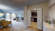 Located at 3005 Chapel Ave in Cherry Hill, New Jersey, this single-floor residence offers a thoughtfully designed layout with a comfortable and cohesive aesthetic throughout. The expansive living room serves as the heart of the home, featuring plush wall-to-wall carpeting, a striking teal accent wall, and a large sliding glass door that floods the space with natural light while providing outdoor access. The open layout flows seamlessly from a cozy sitting nook into the main living area, creating a versatile and inviting atmosphere. The kitchen is well-equipped with dark espresso cabinetry, granite countertops, stainless steel appliances including a gas range, microwave, and dishwasher, and a mosaic tile backsplash that adds a decorative touch. A pass-through window connects the kitchen to the adjacent dining area, enhancing the sense of openness. The dining space is intimate and functional, positioned conveniently between the kitchen and living areas. The bedroom is generously sized with large windows that invite abundant natural light, soft carpeting, and a soothing sage green accent wall. The bathroom features classic white mosaic tile flooring, a dark vanity with an integrated sink, and a full shower-tub combination. Textured ceilings are consistent throughout, adding architectural character to the overall design.