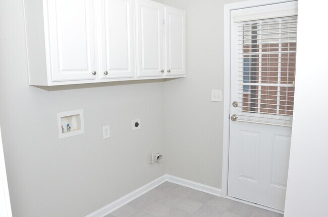 Downstairs Laundry with access to Back yard - 1303 Greychurch Way Townhome