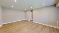 Located at 513 Plymouth Rd in Plymouth Meeting, PA, this well-appointed 2-bedroom, 2-bathroom single-floor residence offers a thoughtfully designed layout with modern finishes throughout. Light wood-tone laminate flooring flows through the open living room and kitchen area, complemented by neutral gray walls and recessed lighting that create a bright, welcoming atmosphere. Large windows with white blinds allow natural light to fill the living space, which offers a generous, open feel.

The galley-style kitchen is well-equipped with white shaker cabinets, granite-look countertops, stainless steel appliances including a gas range, dishwasher, and refrigerator, plus a undermount sink — providing ample functionality and storage.

Both bedrooms feature plush wall-to-wall carpeting, ceiling fans with lighting, and windows with outdoor views. The primary bedroom includes dual closets for generous storage. The two bathrooms are distinctly appointed: one features a soaking tub with large-format tile surround and a rain showerhead, while the other offers a sleek frameless glass walk-in shower with a built-in bench and rain showerhead, both finished with chrome fixtures and coordinating tile.