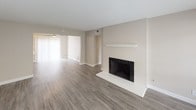 Located at 624-656 S Glendora Ave in West Covina, California, this single-story unit features a thoughtfully updated interior with a neutral color palette and a clean, modern aesthetic throughout. The open living area is highlighted by wood-look plank flooring, a ceiling fan, and a tile-surround fireplace with a white mantel, creating a welcoming focal point. Large windows with blinds allow natural light to fill the space, and a sliding door provides additional brightness and outdoor access.

The kitchen has been updated with white shaker-style cabinetry, light quartz countertops, a peninsula with an integrated sink, and stainless steel appliances including a gas range and full-size refrigerator. Track lighting and a window above the counter contribute to a bright, functional workspace.

The bedrooms feature plush carpeting and neutral walls, offering a comfortable, quiet atmosphere. One bedroom includes a built-in closet with shelving, while windows with blinds bring in views of surrounding greenery. The bathrooms are finished with wood-look flooring, white cabinetry, quartz countertops, and shower-tub combinations, presenting a clean and updated look throughout.