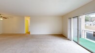 Located at 490 Stamford Dr in Newark, Delaware, this 2-bedroom, 2-bathroom residence offers a thoughtfully designed single-floor layout with a comfortable and functional living environment. The open-concept living and dining area is generously sized, featuring neutral-toned carpet, bright white walls, and sliding glass doors that invite abundant natural light and provide access to an outdoor view. A ceiling fan adds to the comfort of the space. The kitchen is a standout feature, showcasing rich, dark cherry wood cabinetry, granite-style countertops, wood-look flooring, and a full suite of appliances including a refrigerator, electric range, microwave, and dishwasher. A kitchen island with matching cabinetry adds additional prep and storage space. The spacious primary bedroom is carpeted and filled with natural light from a large window, while a wall-mounted heating unit ensures year-round comfort. The second bedroom mirrors this layout with similar finishes and natural light. The two bathrooms are finished with light tile work — one featuring a tub-shower combination and the other a sliding-door walk-in shower with a grab bar, offering practical accessibility. Throughout, the residence maintains a clean, neutral palette that provides a versatile canvas for personalization.