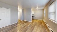 Located at 875 N Easton Rd in Glenside, PA, this single-floor, one-bedroom, one-bathroom unit offers a practical and comfortable layout designed to maximize every square foot. Throughout the space, wood-style plank flooring in warm, natural tones creates a cohesive and inviting atmosphere, complemented by neutral gray and beige wall colors that lend a clean, modern feel.

The living area is generously sized, bathed in natural light from multiple windows fitted with blinds that offer both brightness and privacy. Baseboard heating runs along the walls, providing efficient warmth. The open sightlines connect the living space to a compact kitchen area equipped with white cabinetry and a stainless steel refrigerator, making the overall layout feel open and functional.

The bedroom is a well-proportioned retreat, offering ample room for furnishings along with a double-door closet for convenient storage. Windows allow natural light to filter in, enhancing the sense of space. A dedicated entryway with an additional closet provides practical storage right at the front door.

The bathroom features classic white tile work and clean finishes. A connecting hallway with wood-style flooring ties the rooms together seamlessly. This unit offers a straightforward, well-maintained living environment in a convenient Glenside location.