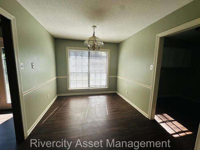 Building Photo - charming three-bedroom, two-full-bath resi...