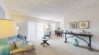 Located on Markstown Drive in Tampa, Florida, this single-floor residence offers a thoughtfully designed layout with a bright, cohesive interior throughout. The open living area is carpeted and bathed in natural light from large sliding glass doors dressed with vertical blinds, creating an inviting atmosphere ideal for both relaxing and entertaining. A dedicated workspace or console area flows naturally from the living space, adding versatility to the floor plan.

The galley-style kitchen features light wood cabinetry, laminate countertops, wood-look flooring, and white appliances, including a refrigerator, dishwasher, and range. It opens directly to the dining area, which benefits from a sunny window and offers a cozy setting for meals.

The bedroom is generously sized with plush carpeting, a textured ceiling, and a window that allows natural light to fill the room. A closet provides ample storage. The full bathroom is clean and functional, featuring a shower-tub combination with a colorful curtain and wood-look flooring.

A hallway connects the private and shared areas of the residence, lined with neutral tones and accented by decorative wall mirrors and framed artwork. The overall ambiance is warm and comfortable, with a consistent coastal-inspired color palette carried throughout the space.