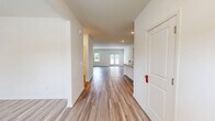 Located at 722 Strickland Row Rd in Dacula, GA, this two-story home offers a well-designed layout across two generously sized floors. The main level features light-toned wood-look flooring throughout, creating a cohesive and clean aesthetic. The open-concept kitchen is a standout, boasting white shaker cabinetry, granite countertops, a central island with sink, stainless steel appliances, and recessed lighting. Two living areas provide flexible space for entertaining or everyday relaxation, with one featuring French doors that open to the backyard, flooding the room with natural light. A foyer entry with a front-facing window welcomes you into the home. The spacious attached garage offers ample room for vehicles and storage. Upstairs, four bedrooms are finished with plush carpet flooring, including a generous primary suite with a walk-in closet equipped with wire shelving. Three well-appointed bathrooms include tub-shower combinations, white vanities, and wood-look flooring. Additional features include multiple closets, two laundry areas, and a private fenced backyard with green lawn space — ideal for outdoor activities. The home's neutral palette and clean finishes create a bright, move-in-ready atmosphere throughout.