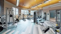 This modern fitness center is thoughtfully designed to support a full range of workout routines. The main exercise area is bright and open, featuring large floor-to-ceiling windows that flood the space with natural light and offer views of an outdoor pool and surrounding building community. A striking orange accent ceiling adds a bold, energizing touch to the space, complemented by contemporary linear lighting fixtures and ceiling fans for comfort during workouts.

The flooring throughout features a stylish multi-toned striped pattern in soft teal and grey tones, lending a clean, modern aesthetic. Full-length mirrors line one wall, visually expanding the space and providing functional feedback during exercise.

The cardio section is well-appointed with multiple treadmills, elliptical trainers, and a stationary bike, all positioned to take advantage of the natural light and outdoor views. The strength training area includes a cable crossover machine, a multi-station cable system, weight benches, free weights, and a variety of selectorized machines — accommodating both isolation and compound exercises.

A separate enclosed studio room, accessible through glass-paned doors, provides additional space for group classes or individual training, and is decorated with motivational artwork. The overall ambiance is modern, clean, and inviting — designed to motivate and accommodate a wide variety of fitness needs.
