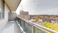 Located on the penthouse level at 120 Raglan Ave in Toronto's Cedarvale neighbourhood, this one-bedroom, one-bathroom residence offers an efficient and well-organized layout across a single floor. The living area is bright and airy, featuring classic parquet hardwood flooring that adds warmth and character throughout. Large windows flood the space with natural light, and a glass-railed balcony extends from the living area, offering sweeping views of the surrounding midtown Toronto skyline and treetops — particularly scenic during autumn foliage season. The galley-style kitchen is neatly designed with white cabinetry, light blue subway tile backsplash, stainless steel appliances including a full-size refrigerator, stove, and dishwasher, complemented by a stainless steel sink and light tile flooring. The bedroom is a comfortable size, featuring the same parquet hardwood flooring, a bright window with neighbourhood views, and baseboard heating. The bathroom is finished in classic white subway tile from floor to ceiling, complete with a soaking tub and shower combination, a pedestal-style vanity, and a large mirror. Baseboard heating is present throughout, and crisp white walls provide a clean, neutral backdrop across all rooms.