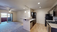 Located at 1195 Selmi Dr in Reno, Nevada, this single-floor residence offers three bedrooms and two bathrooms within a well-organized, functional layout. The open-concept kitchen and living area serves as the heart of the home, featuring dark espresso cabinetry, stainless steel appliances including a gas range, microwave, dishwasher, and refrigerator, complemented by granite-style countertops and a decorative tile backsplash. A peninsula breakfast bar with pendant lighting provides additional prep and seating space, while wood-look flooring ties the kitchen seamlessly to the entry area. The living room transitions to plush carpeting and includes sliding glass door access to a private outdoor patio. Each of the three bedrooms is carpeted and filled with natural light through windows fitted with blinds. The primary bedroom features a ceiling fan and direct patio access, while the additional bedrooms offer comfortable dimensions suited for various uses. A dedicated walk-in closet provides generous storage with wire shelving systems. The bathrooms include a tiled tub-shower combination. Recessed lighting throughout the main living spaces adds a clean, modern touch to this practical and well-appointed Reno residence.