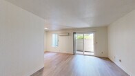 Located at 2950 W Portage Bay Ave in Davis, CA, this single-floor, one-bedroom, two-bathroom unit offers a well-organized layout designed for efficient, comfortable living. Light-toned hardwood-style flooring runs throughout, lending a clean and cohesive look to the interior.

The open living area is bright and airy, benefiting from natural light that filters in through sliding glass doors leading to a private balcony with outdoor views of surrounding greenery. A wall-mounted mini-split unit provides climate control. The space flows naturally into the rest of the unit, creating an inviting and functional atmosphere.

The galley-style kitchen is lined with warm honey-toned wood cabinetry on both sides, offering ample storage. Light countertops, a stainless steel sink, a gas range, and a full-size refrigerator make up the kitchen's functional features, with a window at the far end bringing in additional natural light.

The bedroom is a comfortable, light-filled room with large windows dressed in vertical blinds that frame views of the outdoors. The neutral walls and consistent flooring keep the space feeling open and restful.

Two bathrooms serve the unit — one featuring a vanity with warm wood cabinetry and a large mirror, and the other a compact layout with a combined shower/tub enclosure. Both bathrooms continue the light, clean aesthetic found throughout the unit.