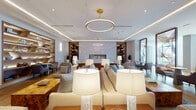 This thoughtfully designed single-floor space presents a series of distinct yet interconnected zones, each crafted with refined attention to detail. The primary lounge area serves as the centerpiece, featuring a generous arrangement of neutral-toned sofas and seating clusters anchored by a sleek linear fireplace set against a softly veined stone accent wall. Overhead, a signature gold hoop pendant light commands attention, complemented by recessed cove lighting that casts a warm, layered glow throughout. Flanking built-in shelving units in rich dark wood display curated décor, adding warmth and depth to the space.

Adjacent seating areas offer varied atmospheres, from intimate conversation groupings to more open lounges with light hardwood flooring, backlit open shelving, and patterned area rugs in blue and gold tones. A dedicated business center provides workstation desks beneath framed artwork, paired with comfortable lounge seating for informal collaboration. A striking diagonal wood-paneled feature wall anchors another lounge zone, housing a recessed fireplace flanked by brass accent furnishings.

A formal conference room features a long walnut table surrounded by mustard-toned chairs, enclosed by steel-framed glass partitions that allow visual connectivity while maintaining privacy. A wide corridor connects all areas seamlessly, reinforcing the space's polished, hospitality-inspired character.