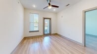 This contemporary apartment in Baton Rouge offers 860 square feet of thoughtfully designed living space. The single-story layout features two bedrooms, including a spacious primary bedroom of 150 square feet, and two full bathrooms. The heart of the home is an open-concept kitchen and living area, showcasing a sleek design with white cabinetry, granite countertops, and stainless steel appliances. Light wood-look flooring runs throughout, complementing the crisp white walls and adding warmth to the space. Large windows in the bedrooms and living areas flood the apartment with natural light, while ceiling fans provide additional comfort. The bathrooms boast modern fixtures and granite vanities. Ample storage is available with two closets and built-in shelving. The apartment's neutral palette and clean lines create a blank canvas for personalization, making it an ideal space for modern living in a prime Baton Rouge location.