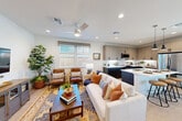 Located at 448 Denton St in Vacaville, CA, this well-appointed two-story home offers three bedrooms, three bathrooms, and a thoughtfully designed layout spread across two floors. The ground floor is anchored by a bright, open-concept living, dining, and kitchen area. The kitchen stands out with two-tone cabinetry — light wood uppers paired with dark lower cabinets — white quartz countertops, a hexagonal tile backsplash, stainless steel appliances, and a large island with an undermount sink. The dining area opens to an outdoor patio through a sliding glass door, allowing natural light to flow freely. The living room features recessed lighting and a ceiling fan, creating a comfortable, airy atmosphere. Upstairs, the primary bedroom includes a spacious walk-in closet with built-in shelving and hanging rods. Additional bedrooms are bright and well-sized, each with closet space and neighborhood views. A versatile bonus room provides flexible living space ideal for a home office or lounge. The bathrooms are finished with clean, modern tile work, including a glass-enclosed walk-in shower with white square tiles and matte black accents. A dedicated laundry area and an attached garage round out the home's practical amenities. Light wood-tone flooring and neutral walls carry a cohesive, contemporary aesthetic throughout.