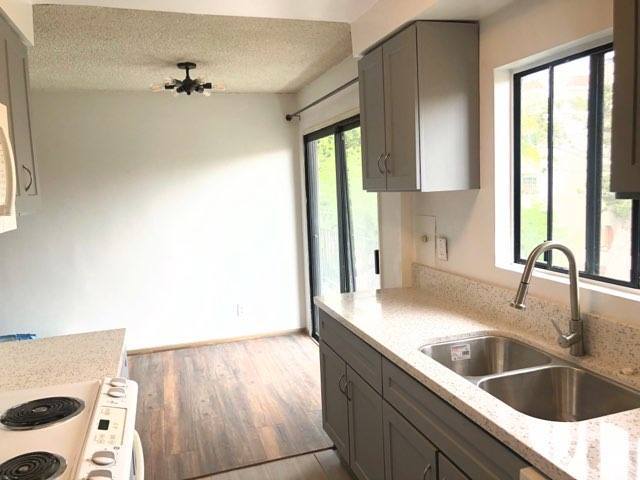 Kitchen with new counters, cabinets, paint, fixtures, and flooring. - 12201 Texas Ave