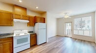Located at 184 Tonea Way in Chico, CA, this thoughtfully designed one-bedroom, one-bathroom unit offers a well-organized layout across a single floor. Light-toned hardwood-style flooring runs throughout, creating a clean, cohesive aesthetic that ties each room together.

The combined kitchen and living area serves as the heart of the unit. The kitchen is well-appointed with warm honey-toned wood cabinetry, granite countertops, recessed lighting, and white appliances including a range, dishwasher, and refrigerator. The adjacent living area benefits from a ceiling fan, a glass door providing direct outdoor access, and window blinds that allow for natural light control.

A hallway connects the main living space to the private areas of the unit, including a closet and the bathroom. The bathroom features a full shower-tub combination with grab bars and wood-style flooring. The bedroom is a comfortable, well-lit room with a large window that brings in natural light and offers views of the surrounding area. Neutral wall tones throughout the unit complement the light flooring, creating a bright and welcoming atmosphere. This unit is a practical and comfortable home in a convenient Chico location.