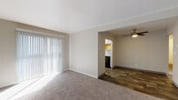 Located at 4124 S 430 E in Salt Lake City, Utah, this single-floor unit offers a thoughtfully arranged layout with a comfortable, neutral aesthetic throughout. The living area features soft carpeting and a large sliding glass door dressed with vertical blinds, allowing abundant natural light to pour in. This space flows seamlessly into the dining area, which is finished with wood-look plank flooring and a ceiling fan overhead — a practical and stylish touch.

The kitchen is well-appointed with white cabinetry, granite-style countertops, black appliances including a refrigerator and range, a stainless steel sink, and a window that brings in additional daylight. The clean, galley-style layout maximizes functionality.

Multiple bedrooms are carpeted and feature neutral-toned walls, windows with blinds for natural light and privacy, and ceiling-mounted light fixtures. Each room provides a versatile, move-in-ready canvas.

The bathrooms are finished with wood-look plank flooring, white vanity cabinetry, granite-style countertops, brushed gold faucets, large mirrors with overhead lighting, and towel bars — combining practicality with a modern aesthetic. The overall design of the unit is clean, bright, and consistent, creating a welcoming atmosphere throughout.