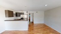 Located in Houston's 77023 neighborhood, this single-floor, one-bedroom, one-bathroom home offers a well-planned layout that maximizes every inch of its intimate footprint. Warm hardwood flooring runs throughout the entire space, creating a cohesive and inviting atmosphere from room to room.

The kitchen is a standout feature, designed with functionality and style in mind. It showcases grey cabinetry with a classic raised-panel design, rich butcher block countertops, a peninsula that opens to the living area, and stainless steel appliances including a gas range and full-sized refrigerator. A single-basin sink and open shelving round out this practical yet attractive culinary space.

The bedroom is a comfortable retreat, featuring a ceiling fan with light fixture, a window that brings in natural light with views of the backyard, and direct access to a dedicated walk-in closet. A second closet provides additional storage options elsewhere in the home.

The bathroom is clean and straightforward, featuring a full tub-shower combo with white surround panels, a toilet, and the same warm hardwood flooring that ties the space together. A hallway connects the rooms efficiently, contributing to the home's smart and functional single-level flow.