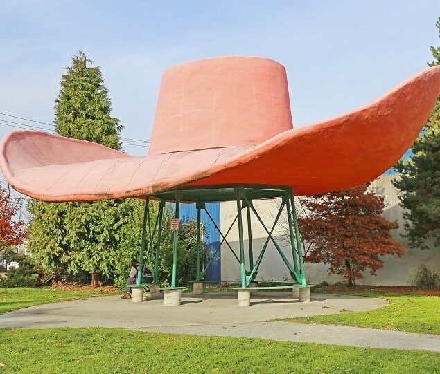 A large, orange cowboy hat serves as part of the roadside attraction, “Hat ‘n’ Boots”