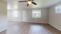 This 550-square-foot, one-bedroom, one-bathroom unit is located on 50th Ave N in Saint Petersburg, FL. The single-floor layout is thoughtfully arranged to maximize functionality across the living room, kitchen, bedroom, bathroom, and laundry area. Light wood-style luxury vinyl flooring runs throughout, creating a clean and cohesive aesthetic.

The open living room features multiple windows that bring in natural light and greenery views, complemented by a ceiling fan with light fixture. The kitchen is well-appointed with white shaker-style cabinetry, granite countertops, a tile backsplash, a stainless single-basin sink, and black appliances including a refrigerator and electric range.

The primary bedroom measures 160 square feet and includes a ceiling fan, a natural light window, and a built-in closet with shelving. The bathroom offers a white vanity with granite countertop, a large illuminated mirror, tile backsplash, and a shower-tub combo. A dedicated laundry room provides additional utility space with a water heater. The unit's neutral color palette and updated finishes provide a move-in-ready appeal throughout.