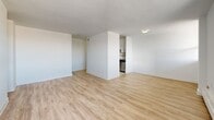 Located at 739 Birchmount Road, Suite 308 in Toronto's Scarborough neighbourhood, this three-bedroom, one-bathroom unit offers a practical and well-laid-out single-floor living space. The open living and dining area is bright and welcoming, featuring light laminate wood flooring and a large window that brings in natural light, with direct access to a private balcony overlooking the surrounding greenery. The adjacent kitchen is efficiently designed with white cabinetry, dark countertops, and stainless steel appliances, including a full-size refrigerator and stove. A clean corridor connects the main living areas to the three bedrooms, each characterized by classic parquet flooring and individual windows that provide natural light and outdoor views. The primary bedroom offers a generous footprint with built-in closet storage. The additional bedrooms are well-proportioned and versatile. The bathroom features a wide granite-style countertop vanity with an integrated sink and a large mirror. A dedicated closet provides additional storage within the unit. Throughout, the space is finished with crisp white walls, creating a clean and neutral backdrop suitable for a variety of living arrangements.