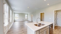 Located at 2762 Lascassas Pike in Murfreesboro, Tennessee, this well-appointed two-story home offers a thoughtfully designed layout across two floors. The main level welcomes you through a bright, soaring entrance foyer filled with natural light from tall windows. The open-concept living, dining, and kitchen area forms the heart of the home, featuring light hardwood-style flooring, recessed lighting, and a neutral color palette throughout. The kitchen is equipped with stainless steel appliances, soft gray cabinetry, a white quartz countertop island with a double-basin sink, and ample storage. The main floor also includes a garage with a generous footprint and convenient interior access. Upstairs, the primary bedroom is a spacious retreat with multiple windows offering views of the surrounding neighborhood and abundant natural light. The primary bathroom features a dual-sink vanity with quartz countertops and hardwood-style flooring. Three additional well-sized bedrooms with plush carpeting and dedicated closets provide flexible living space. A dedicated laundry room houses side-by-side washer and dryer units with overhead wire shelving. Four closets throughout the home, including one with built-in wire shelving, ensure excellent storage capacity. The staircase features a warm wood handrail with crisp white trim, tying together the home's clean, modern aesthetic.