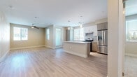 Located at 13250 Foothill Blvd in Rancho Cucamonga, CA, this single-story 2-bedroom, 2-bathroom residence offers a thoughtfully designed open-concept layout with contemporary finishes. The combined kitchen and living area serves as the heart of the home, featuring light wood-look flooring, neutral warm-toned walls, and abundant natural light from multiple windows with blinds. The kitchen is well-equipped with stainless steel appliances, a gas range, a built-in dishwasher, and a large French door refrigerator. A central island with a white quartz countertop provides additional prep space and casual seating, complemented by two-tone cabinetry in white and wood-grain finishes and pendant lighting overhead. A ceiling fan in the living area adds comfort and functionality. Both bedrooms are generously sized, with the primary bedroom offering plush carpeting, a ceiling fan, and access to a dedicated closet. The second bedroom features light wood-look flooring and a window with outdoor views. Each bathroom is finished with large-format tile flooring and a tub-shower combination, and one bathroom offers direct access to a walk-in closet with built-in shelving. The overall design is clean, modern, and move-in ready.